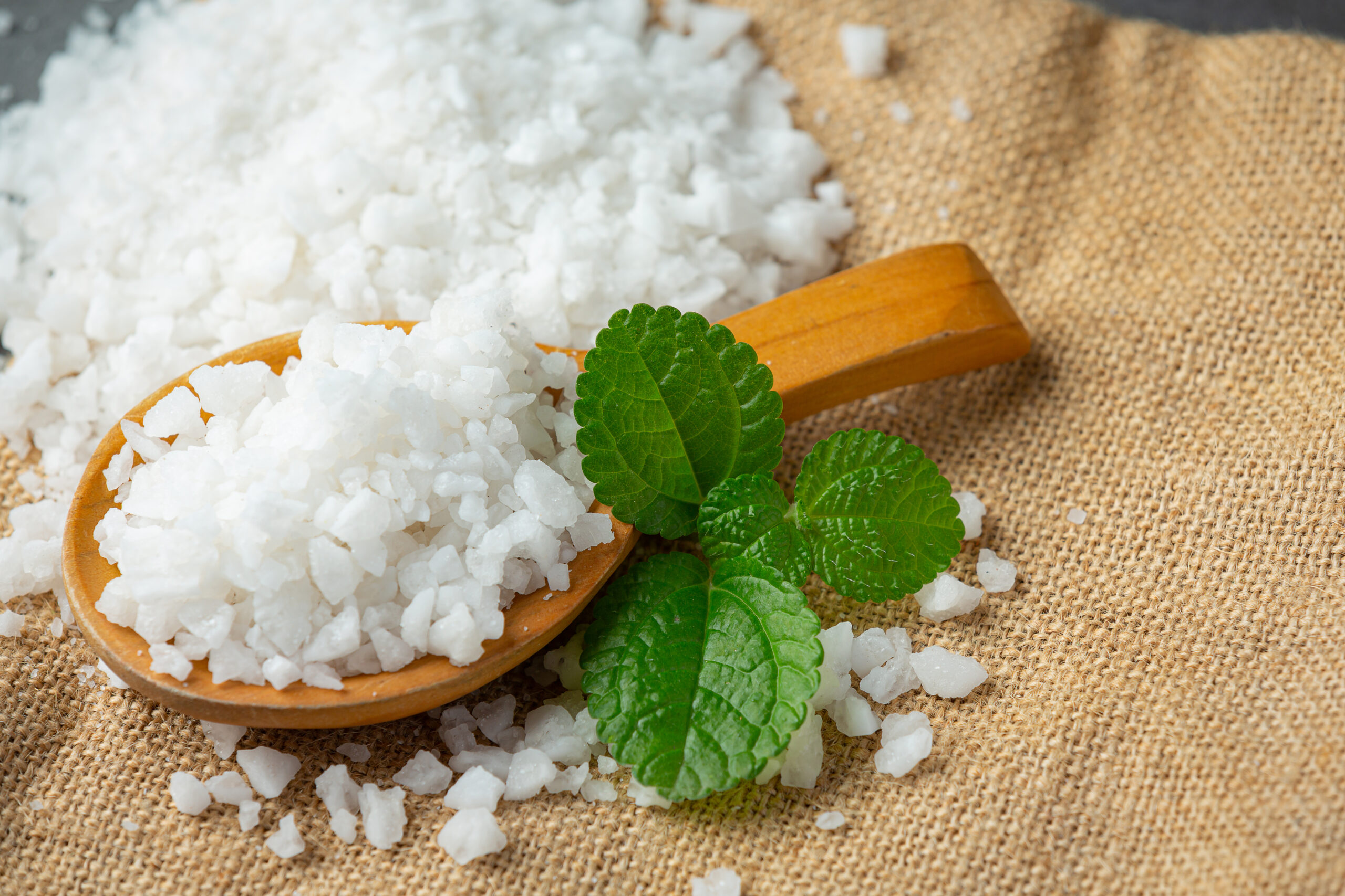 salt in wooden spoon place on floor